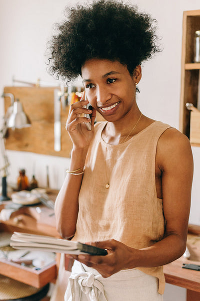 Jewelry designer taking new order on phone