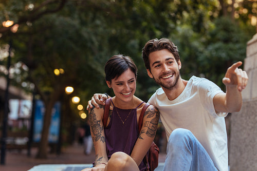 Tourist couple sitting outdoors