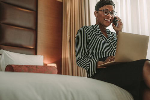 African businesswoman on tour working from hotel room