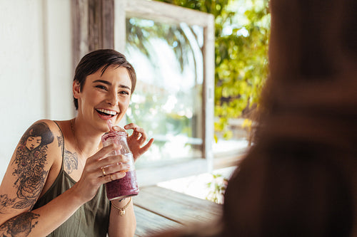 Woman drinking a smoothie at a restaurant