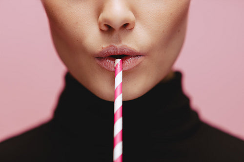 Face of a woman with straw