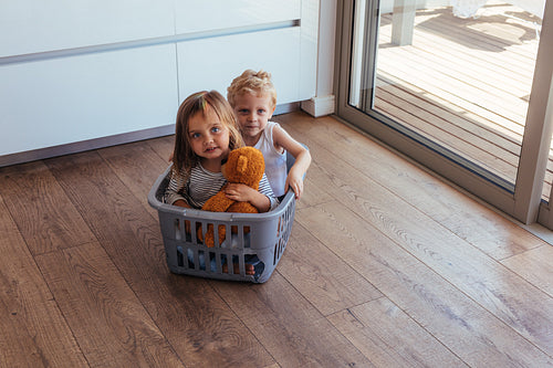 Children sitting in a washing basket