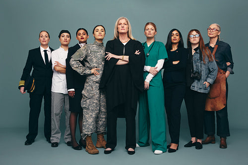 Empowered female workers standing together in a studio