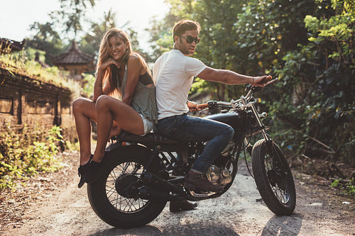 Beautiful young couple on a motorbike