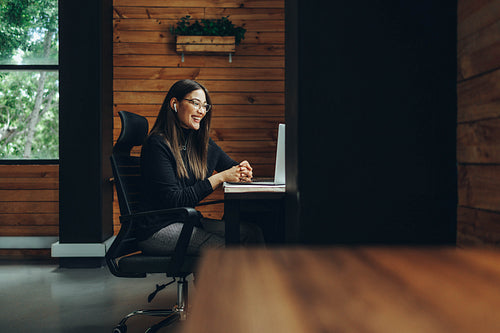 Young businesswoman having a virtual meeting in a coworking spac