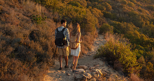 Hiker couple walking through mountain trail