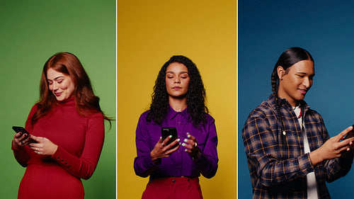 Three Gen Z young people smiling and laughing while using their smartphones on colorful backgrounds