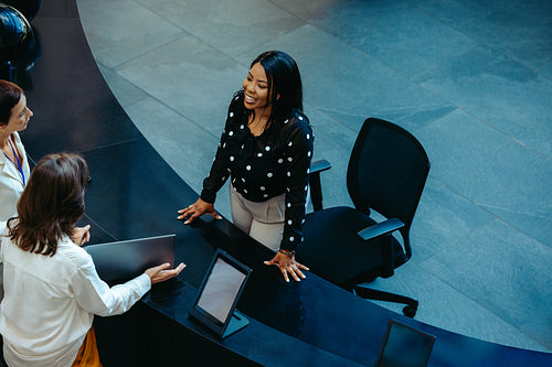 Friendly female receptionist at an office building desk