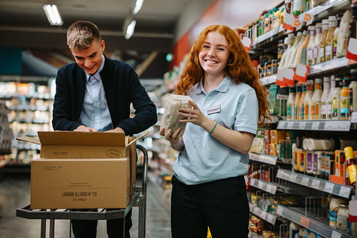 Young worker restocking the shelves