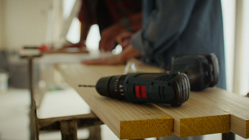 Planning for the future: Couple discusses renovation ideas over blueprints