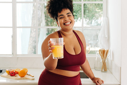 Fitness woman showing glass of juice