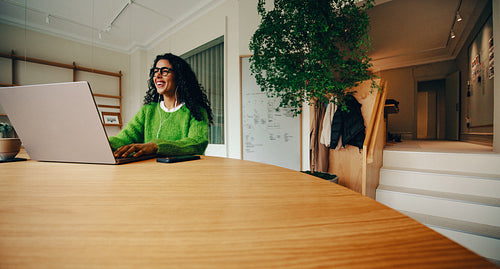 Her workday shows a work routine with phone and laptop at the office desk