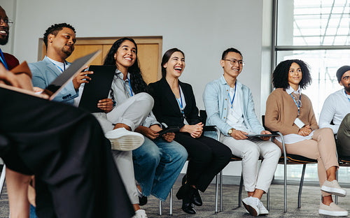 Joyful team in an office setting networking and smiling during a casual meeting