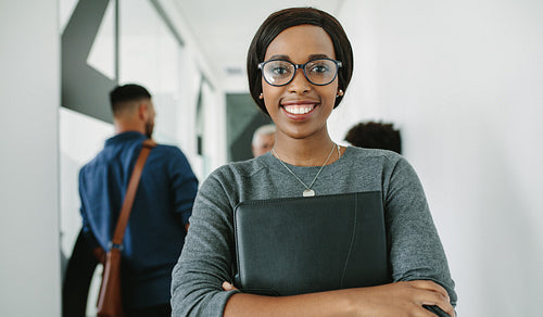 Cheerful business woman in office corridor