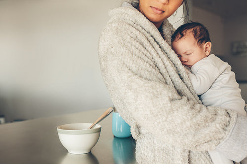 Newborn baby boy sleeping in his mother's hands