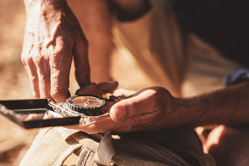 Man using compass for directions