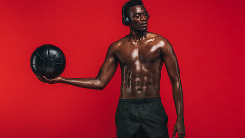 African american man exercising with a fitness ball