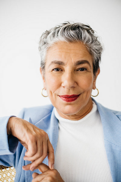 Portrait of a confident grey-haired business woman sitting in her office