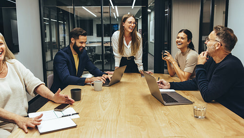 Colleagues laughing during a meeting