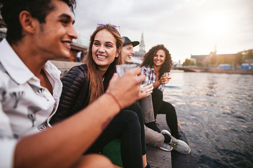 Young woman sitting with her friends having drinks