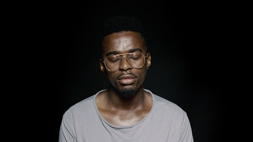 African man with eyes closed