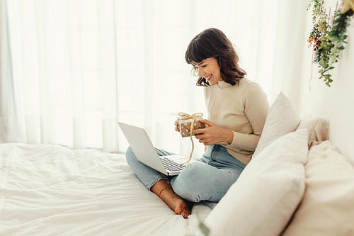 Woman showing christmas presents on video call