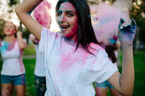 Woman celebrating festival of colors with friends