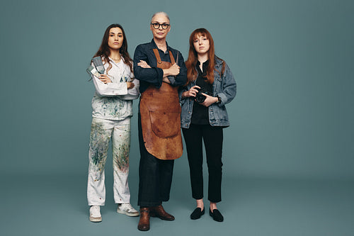 Three women from different creative occupations standing in a st