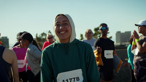 Cheerful woman gives thumbs up at race
