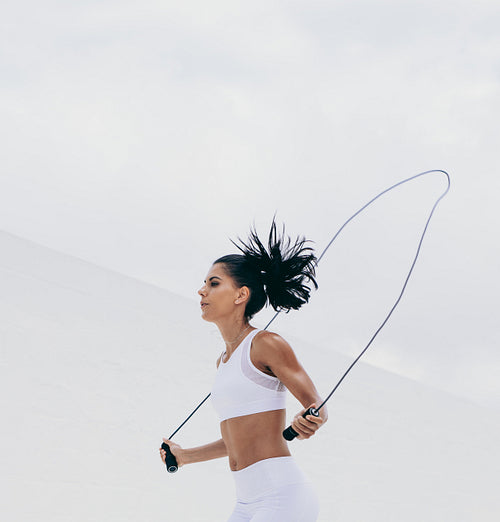 Fitness woman doing workout using a skipping rope