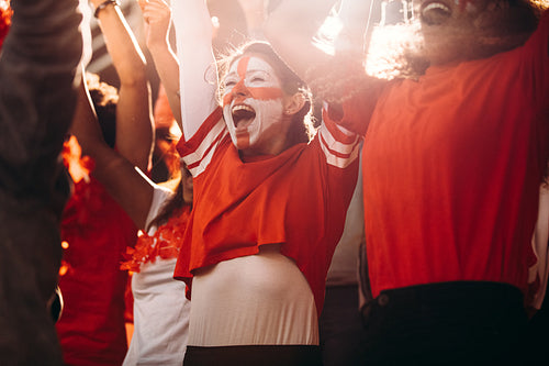 English football fans cheering over a goal in stadium