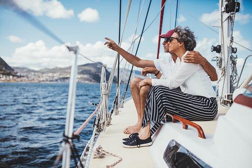 Senior couple sitting on boat looking at the sea