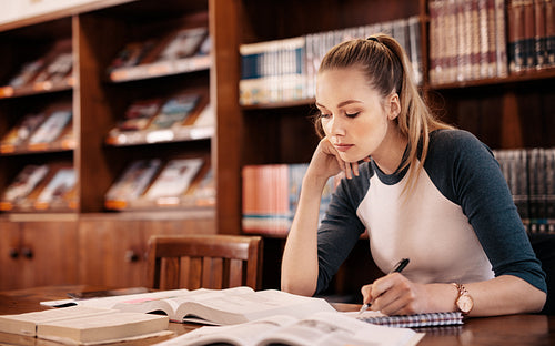 Young caucasian student learning from book