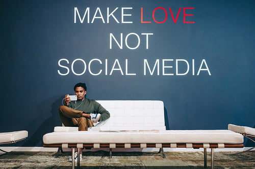 Young businessman taking a video call in an office lobby