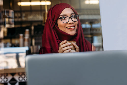 Pretty islamic girl in hijab at coffee shop