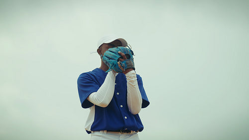Baseball player pitches ball during a game