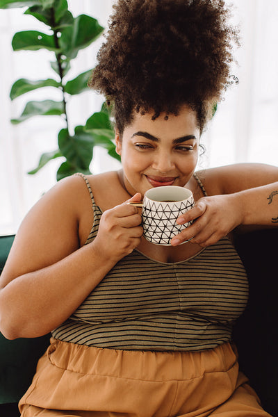 Woman drinking coffee at home