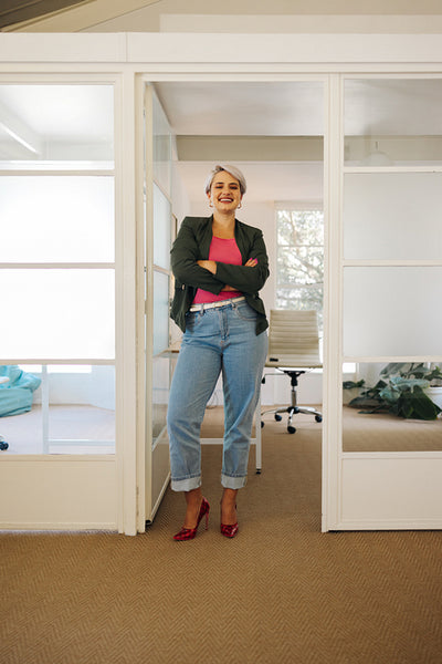 Modern businesswoman smiling at the camera in an office