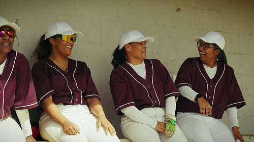 Baseball teammates share laughter in the dugout