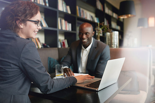 Happy young people in a business meeting at restaurant