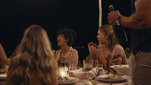 Friends having a great time at an evening dinner party