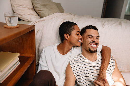 Two men sharing a fun joyful moment at home