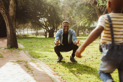 Boy running towards his father