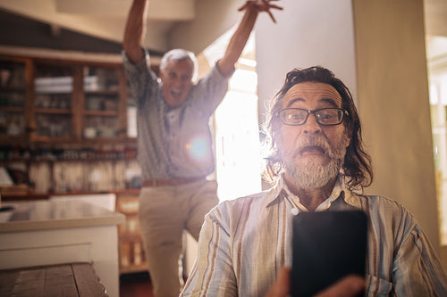 Cray old people man making self portrait