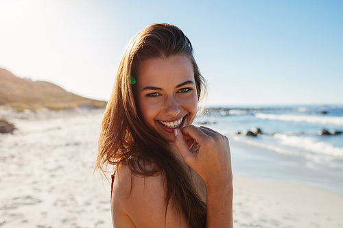 Beautiful young woman smiling on the beach