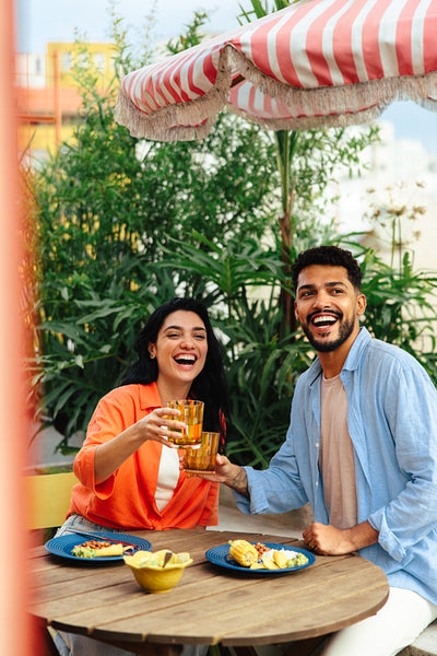 Friends enjoying an outdoor meal at a casual and vibrant gathering