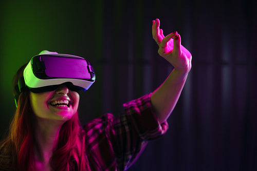 The future of fun: Woman smiling as she interacts with virtual reality