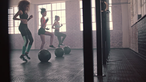 Three females doing workout together in gym