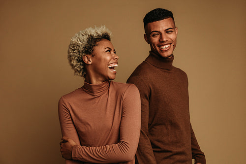 Fashionable african american couple on brown background