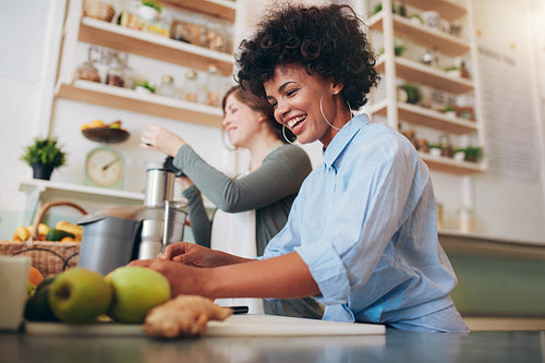 Smiling young employees working at juice bar